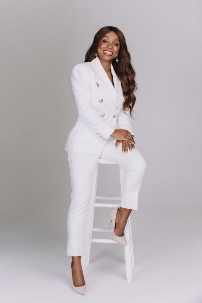 Dr. Chanel Suggs in a white suit